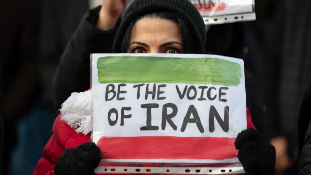 A protester holds a sign reading “Be the voice of Iran” during a rally in London on Jan. 17.