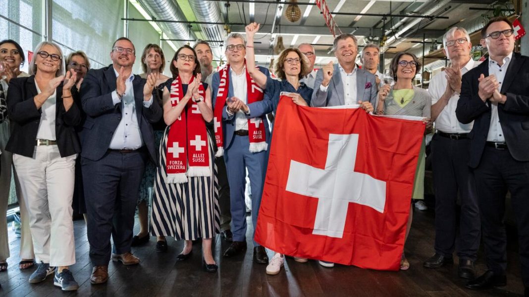 Members of the Federal Parliament and other representatives of civic organizations, celebrate during a get together of a cross-party alliance against the SVP's popular initiative 