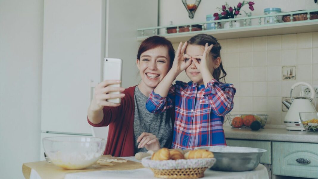 A mother and child posing for social media
